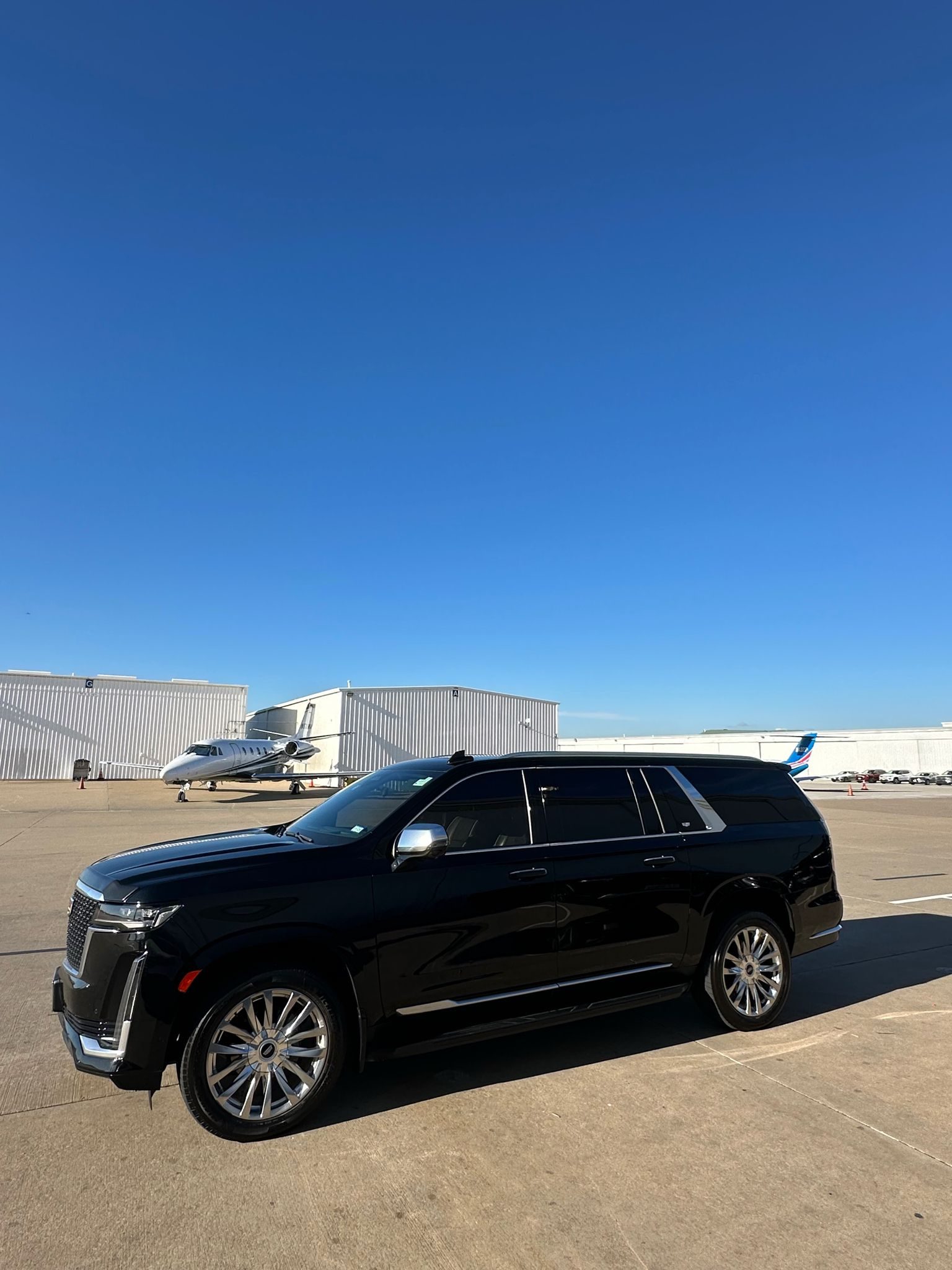 Black Suburban in front of building